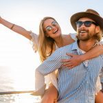 RP attractive happy couple laughing traveling summer by sea