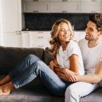 RP joyful day together cozy warm apartments happy attractive guy with beautiful girl looking each other laughing hugging sofa 1